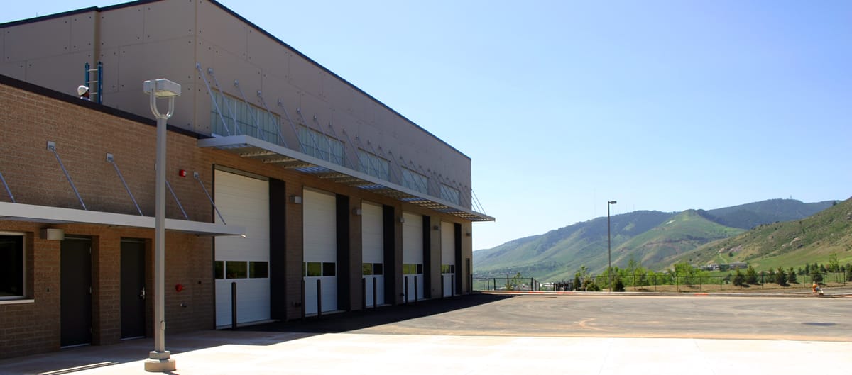 Large garage doors and mountains in background